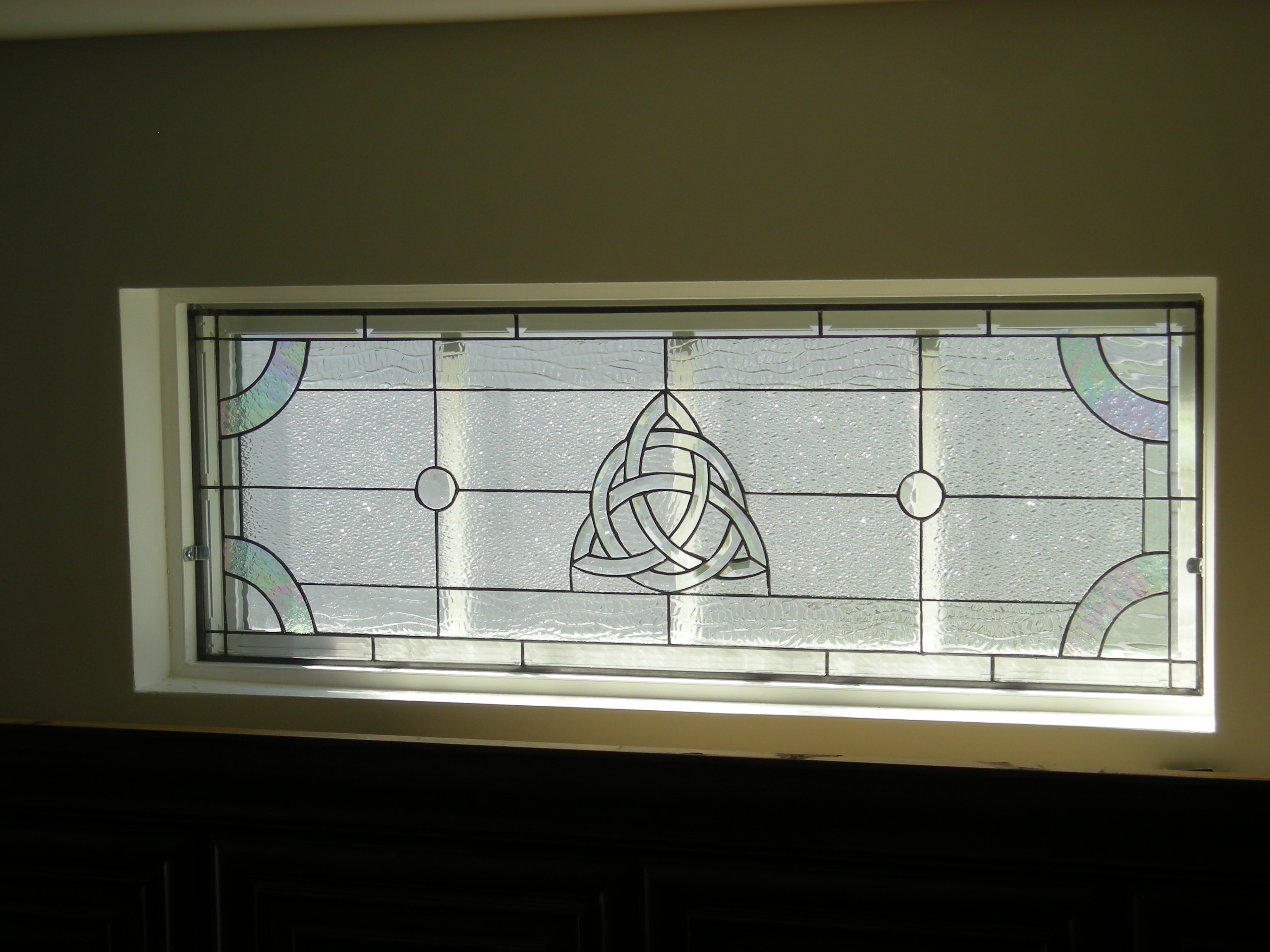 Stained Glass Celtic knot window insert held in with mirror clips