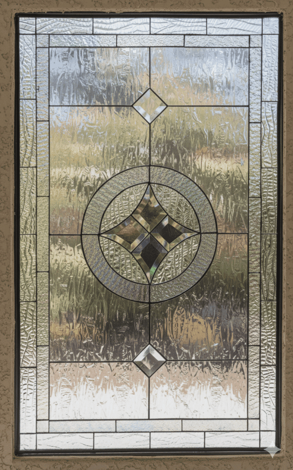A rectangular leaded glass window with a formal, geometric design. It features a central beveled glass cluster of a diamond within a circle, flanked vertically by two smaller diamond bevels, all set against a background of heavily textured clear glass for privacy.