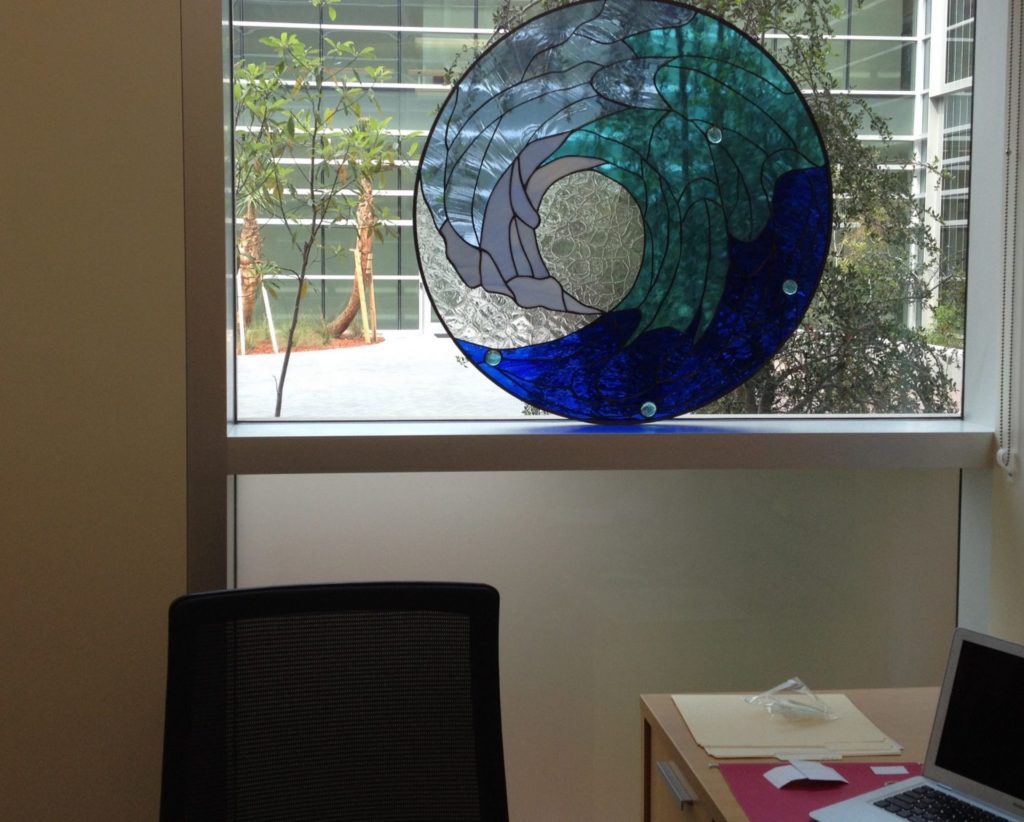 Round Stained Glass Cresting Wave Set In Window Sill