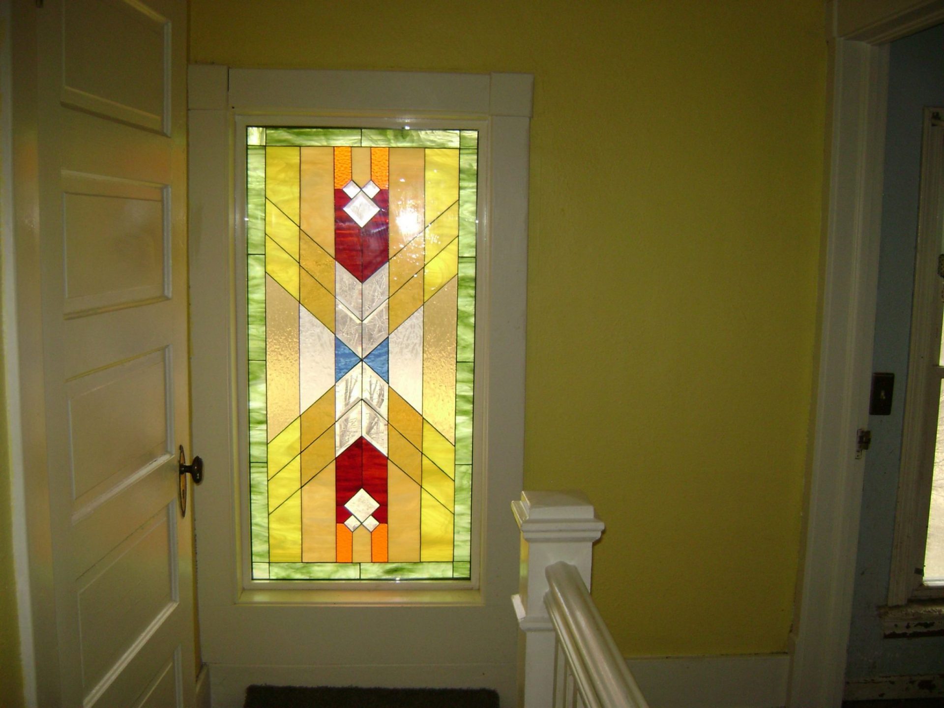 Stained glass insert simply trimmed in over existing window