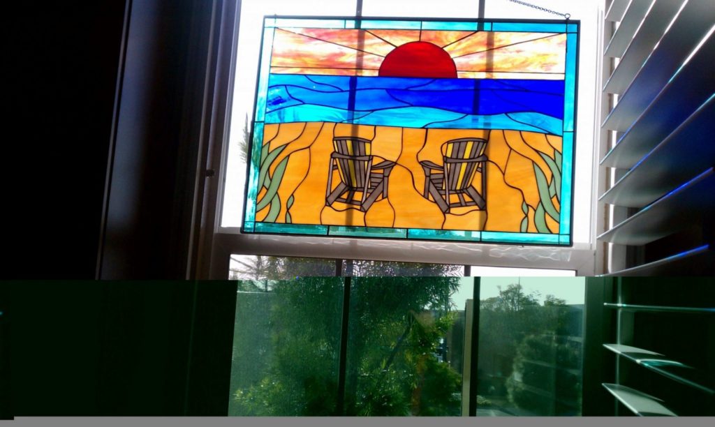 Stained Glass Panel Hung In The Window Beach Chairs And Sunset