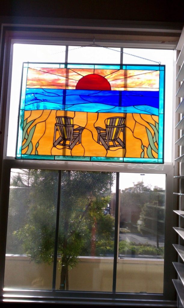 Stained Glass Panel Hung In The Window Beach Chairs And Sunset