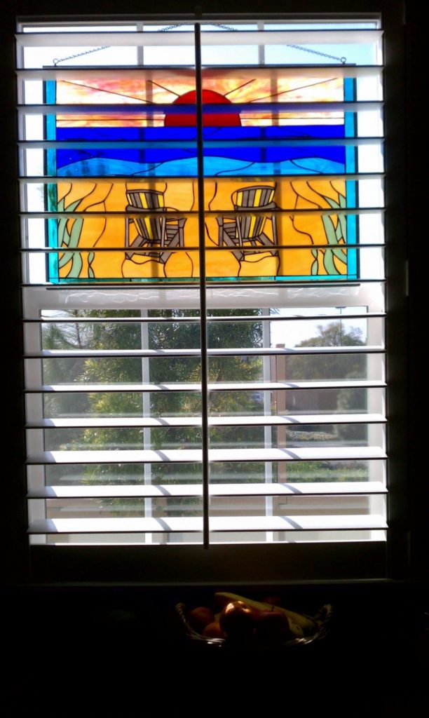Stained Glass Panel Hung In The Window Beach Chairs And Sunset