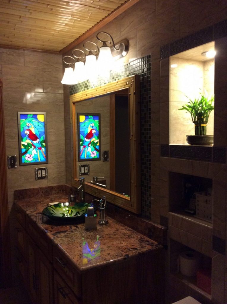 Artificially Backlit Parrot Stained Glass Window Panel installed in a bathroom