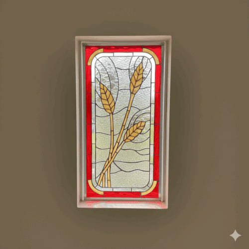 A rectangular stained glass panel depicting three stylized golden wheat stalks against a clear wavy textured glass background, bordered by a vibrant red frame with yellow accents.