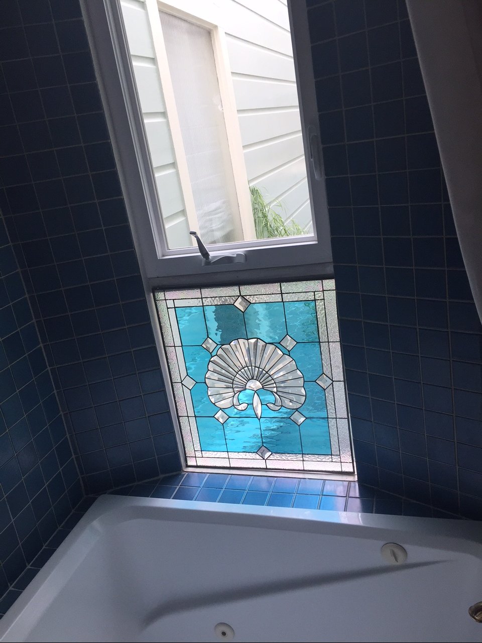 Beveled Seashell Stained Glass WIndow Installed Over Bathtub