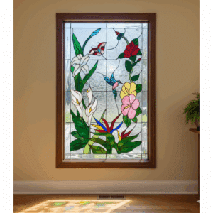 A rectangular leaded stained glass panel depicting a vibrant tropical garden scene with white calla lilies, pink and yellow hibiscus, a red rose, bird of paradise flowers, a blue hummingbird, and a red butterfly, set against a textured clear glass background within a wooden frame.