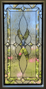 Rectangular clear stained glass panel with a symmetrical abstract design composed of various textured glass pieces and dark lead lines.