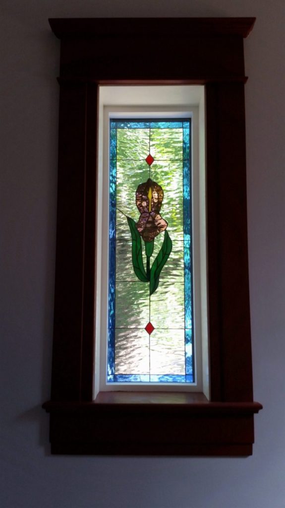 Stained glass window insulated and installed into vinyl frames