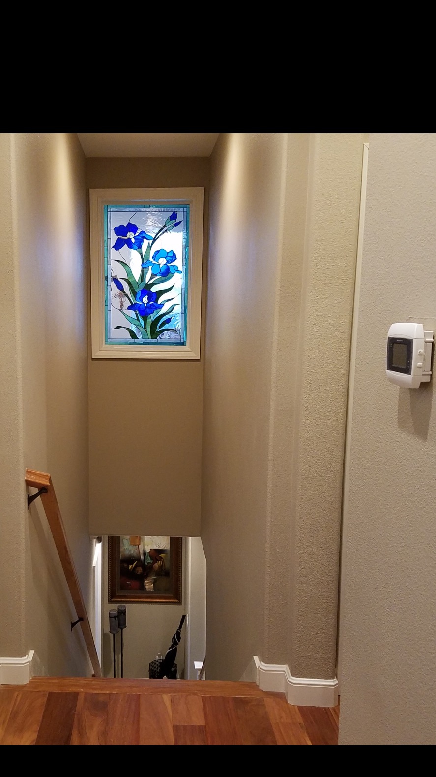Lovely "iris trio" stained glass window installed over a stairway
