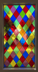 A rectangular leaded glass window featuring a traditional Harlequin diamond lattice pattern. The panel is a vibrant mosaic of multi-colored, textured glass panes, including shades of red, blue, green, and yellow.