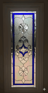 A rectangular stained glass panel with a vibrant blue border, clear beveled glass, and textured clear glass featuring floral and scroll motifs.