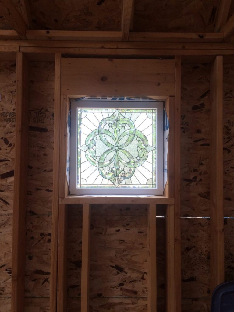 One of our beveled windows just being installed during the beginning construction phase!