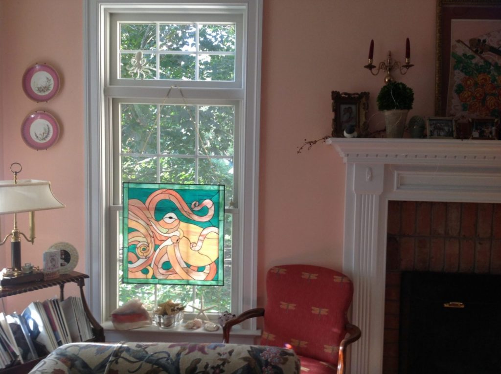 Octopus stained glass window hung with chains and hooks