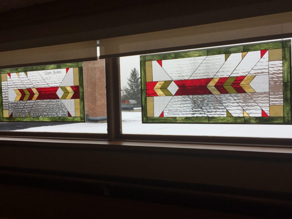 Two stained glass windows hung in a Church with personalized text