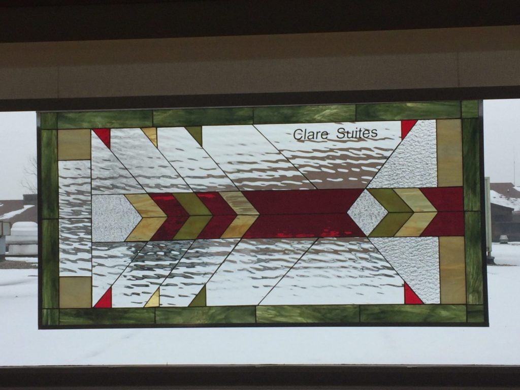 Stained glass windows hung in a Church with personalized text