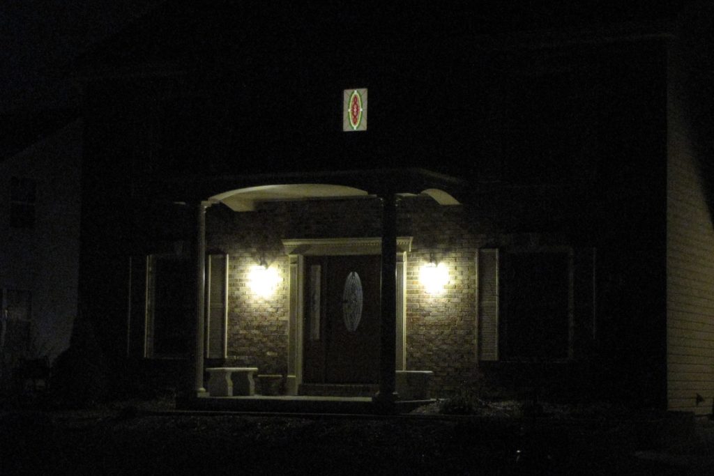 stained glass window installed above an entryway