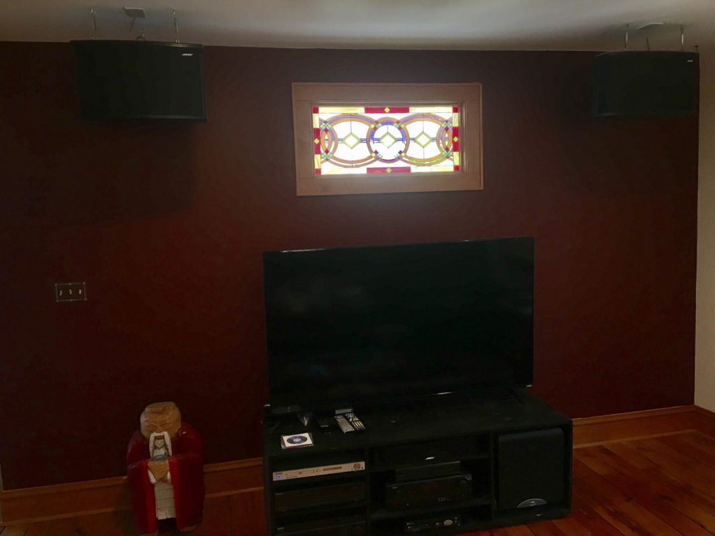 Colorful Geometric Window Installed Over A Television In a Living Room