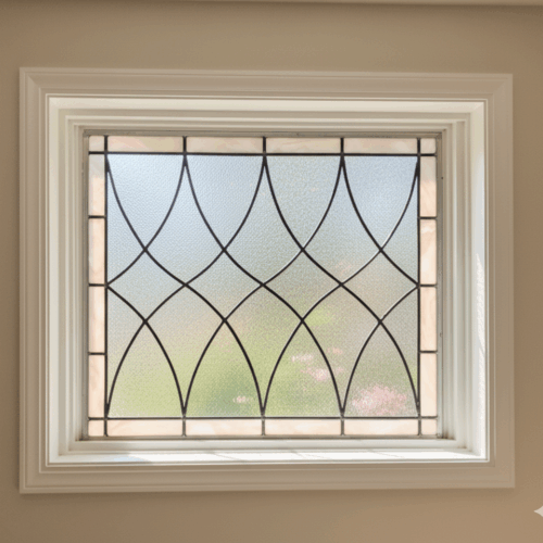 A rectangular stained glass panel with a classic, repeating pattern of curved, pointed oval shapes. The central design is made of clear, textured privacy glass and is framed by a simple border of off-white opalescent glass.