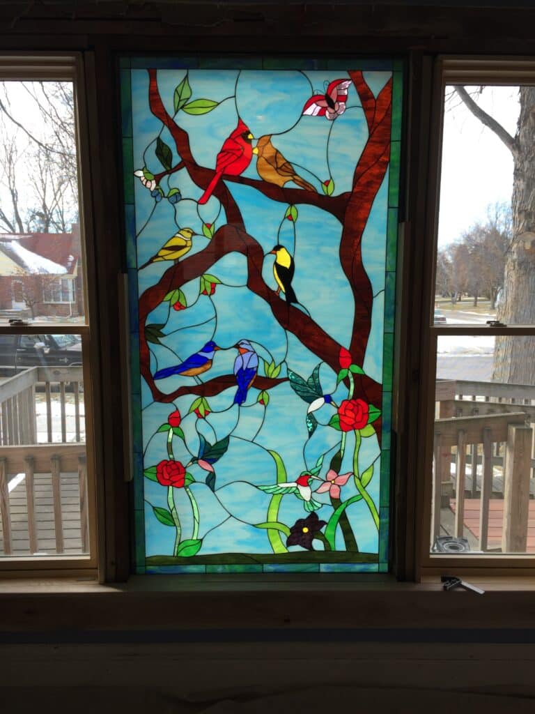 A Large bird Gathering Window Installed In A Living Room Applique freeapplique