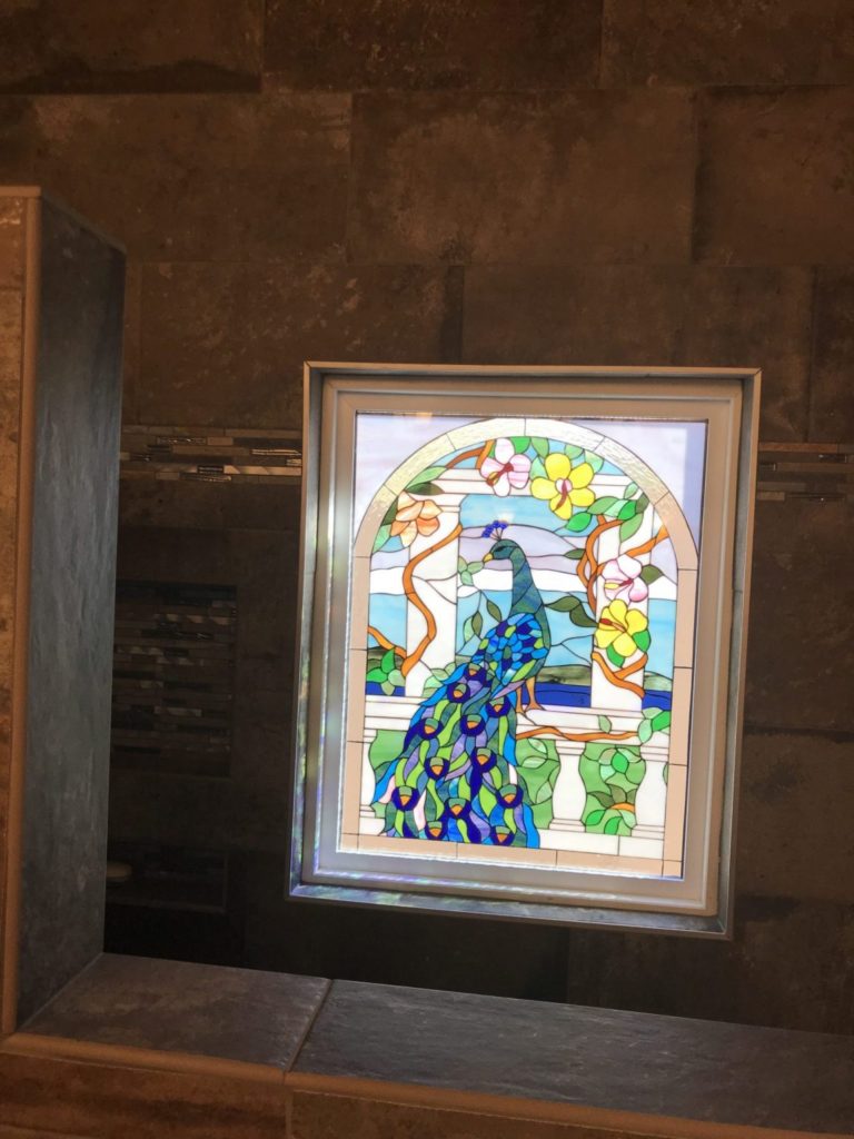 "Peacock & Magnolia Flowers" stained glass window installed in shower