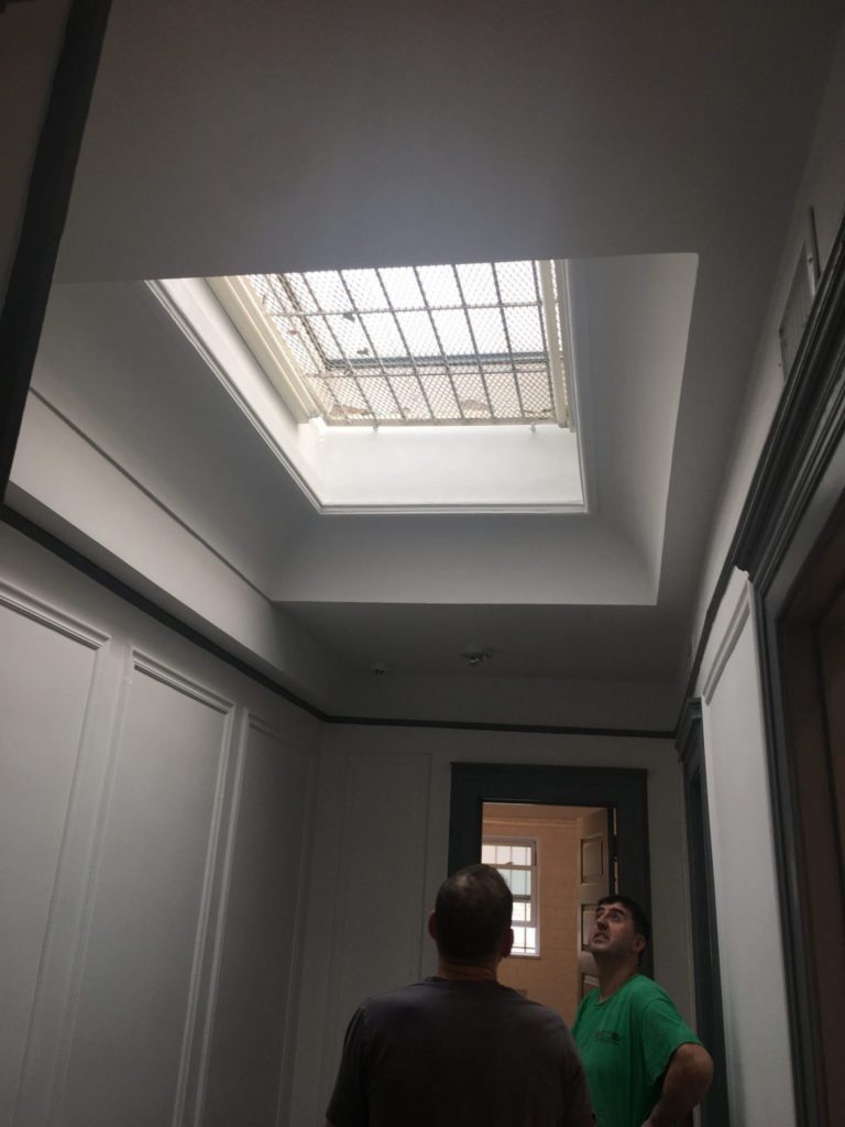 Large skylight insulated in clear tempered glass above a stairway (Before)