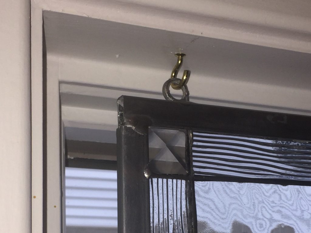 Beveled Celtic Knot Window Installed With Hooks