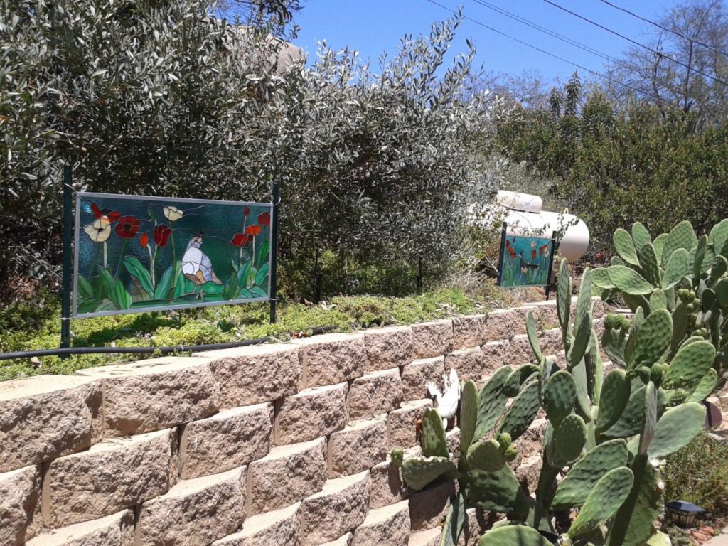 Two Stained Glass Windows Put Into A Garden Area