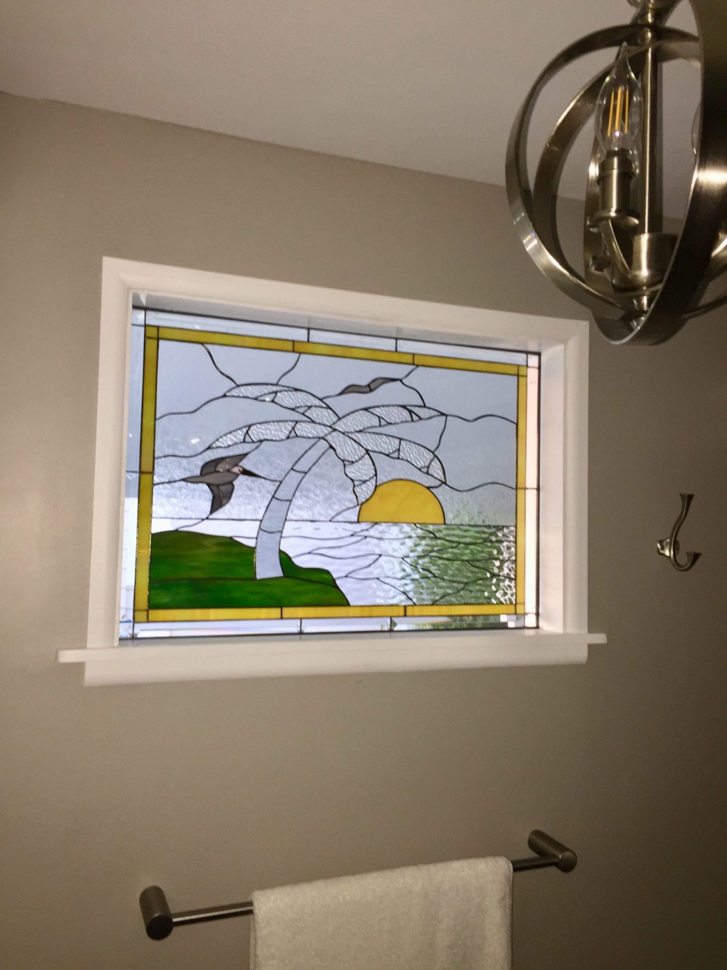 Beautiful palm tree and seagull window installed in bathroom for natural light and beauty!