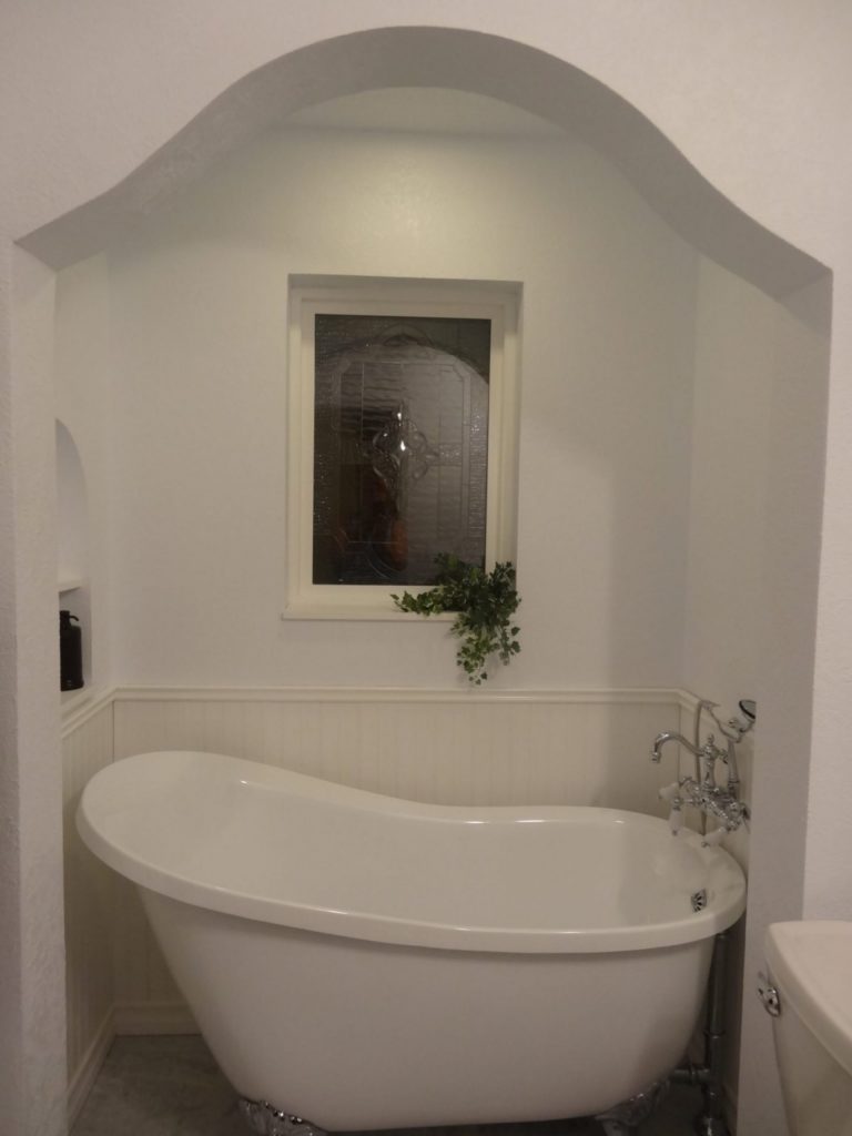 A beveled leaded artglass window installed over bathtub