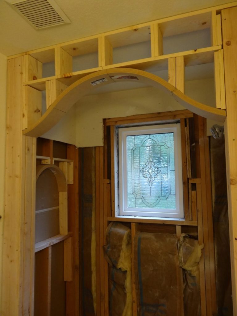 A beveled leaded artglass window installed over bathtub