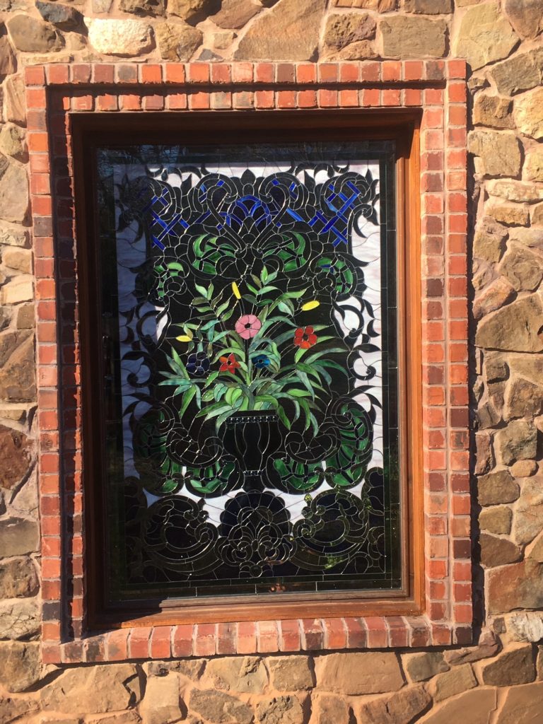 A massive intricate colorful floral insulated stained glass window installed in Texas