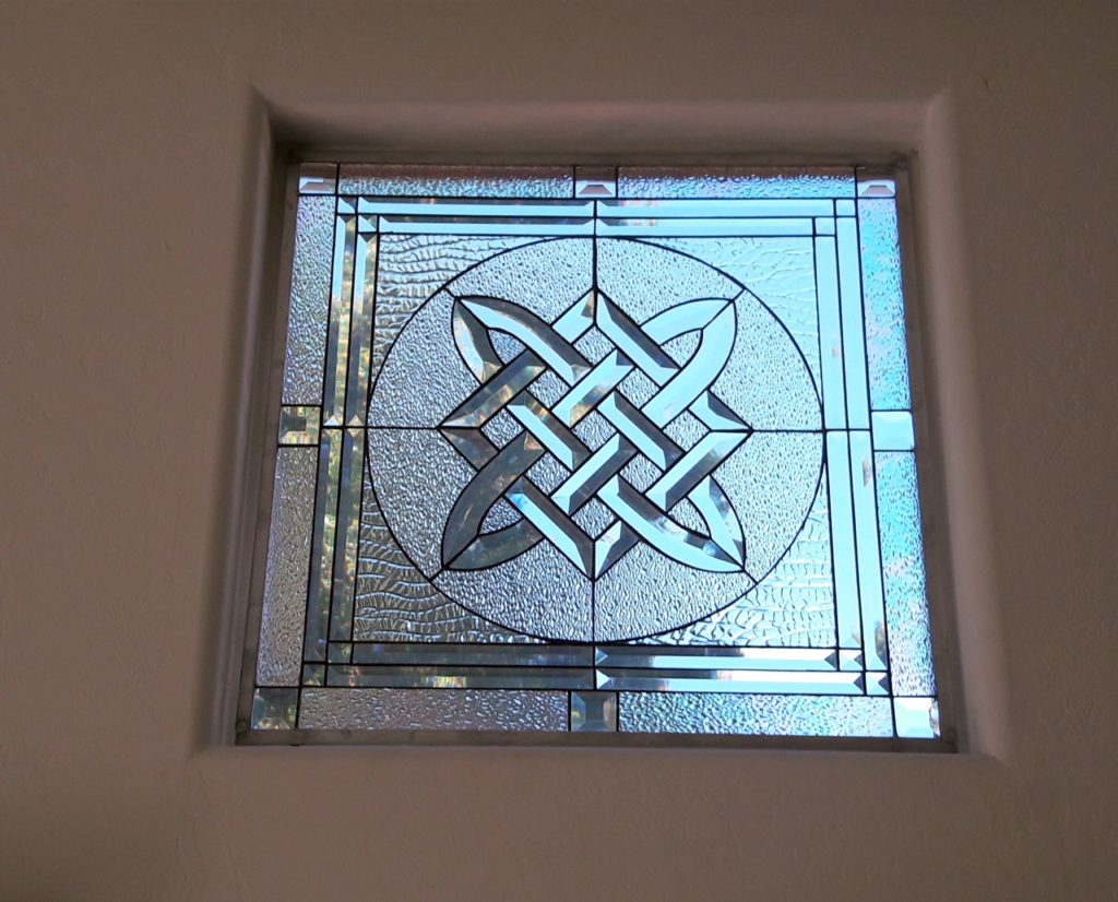 stained glass windows simply hung with hooks in front of existing windows