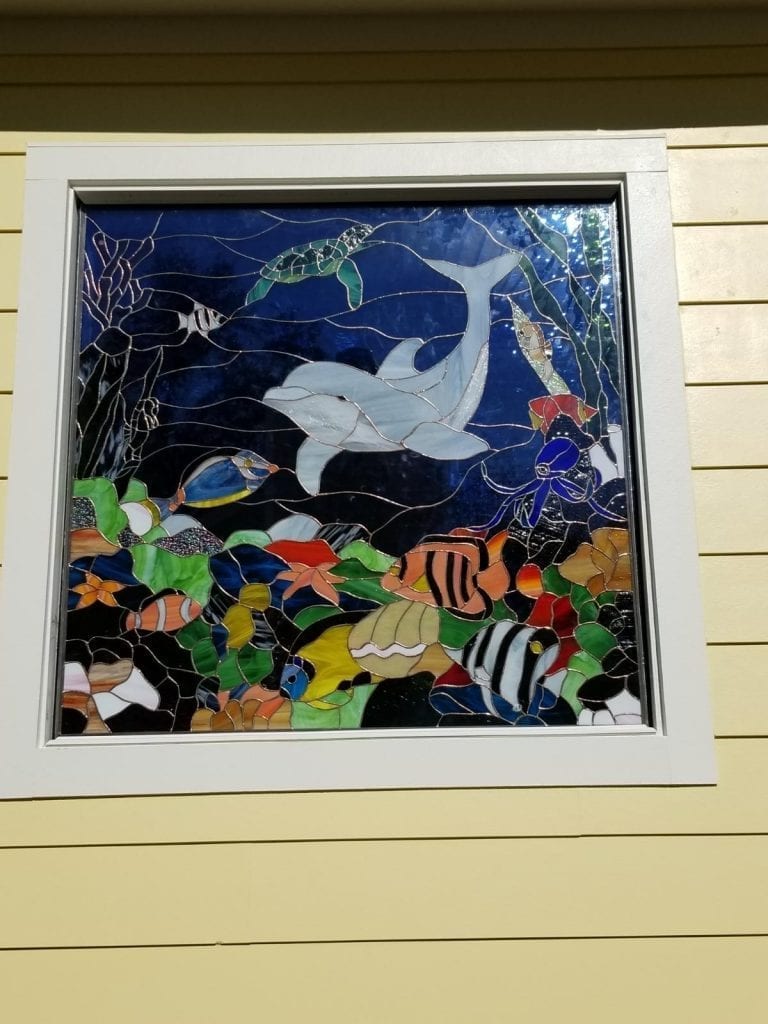 Dolphin, Sealife, and Coral Stained Glass Window Installed In A Bathroom Exterior