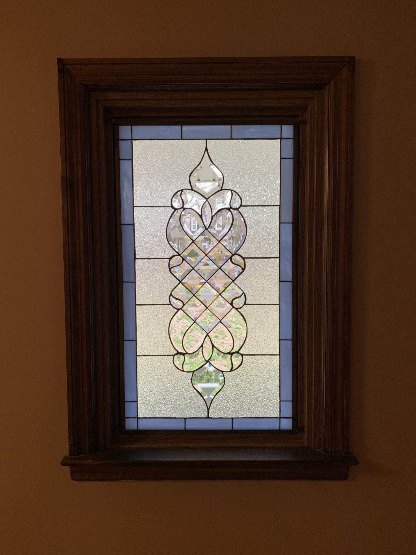 The "Laguna Stained & Beveled Window" installed in a wood frame by our client