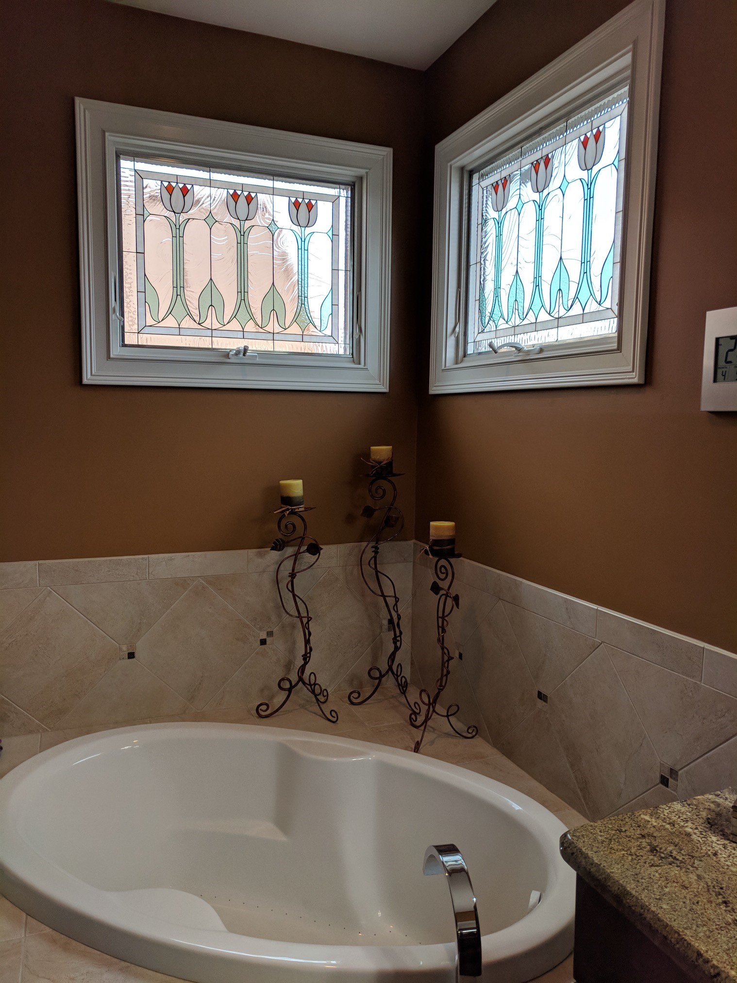 Elegant Crank-out stained glass English tulip windows installed in a bathroom