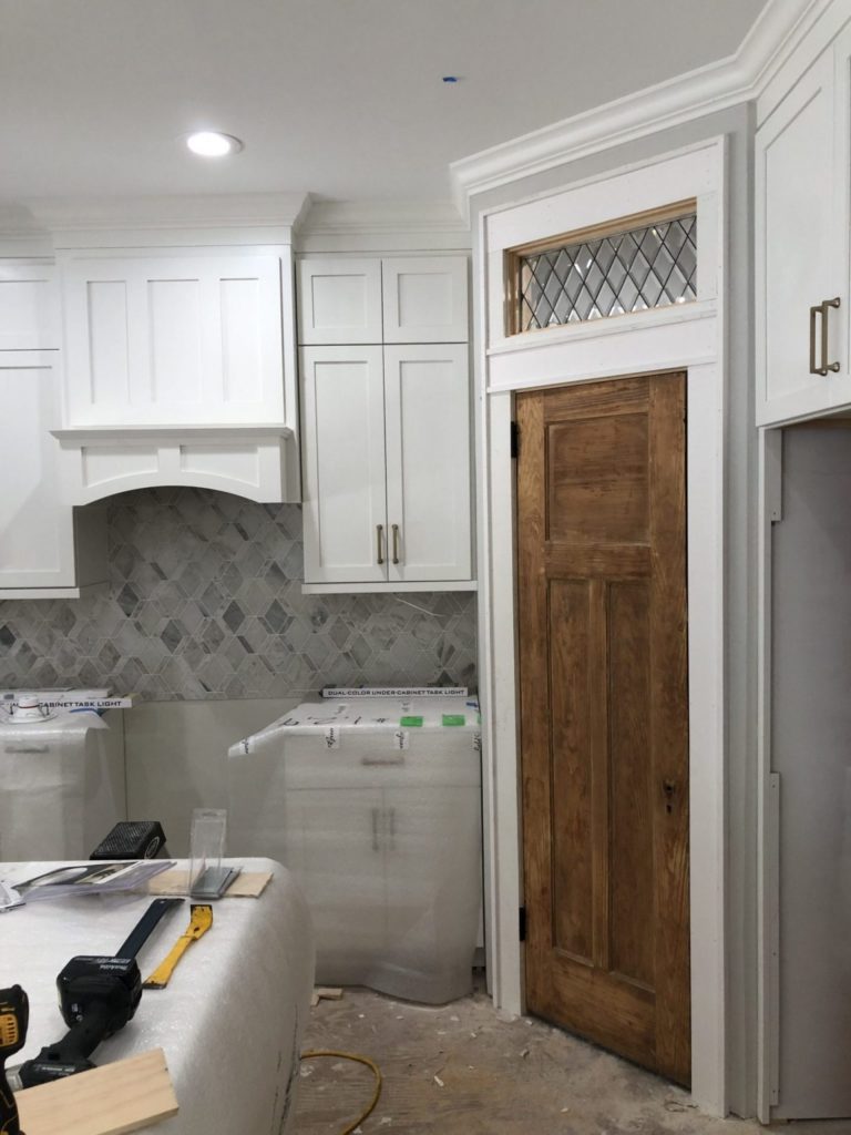 Classic Beveled Diamonds Used As A Transom Window In A Laundry Room