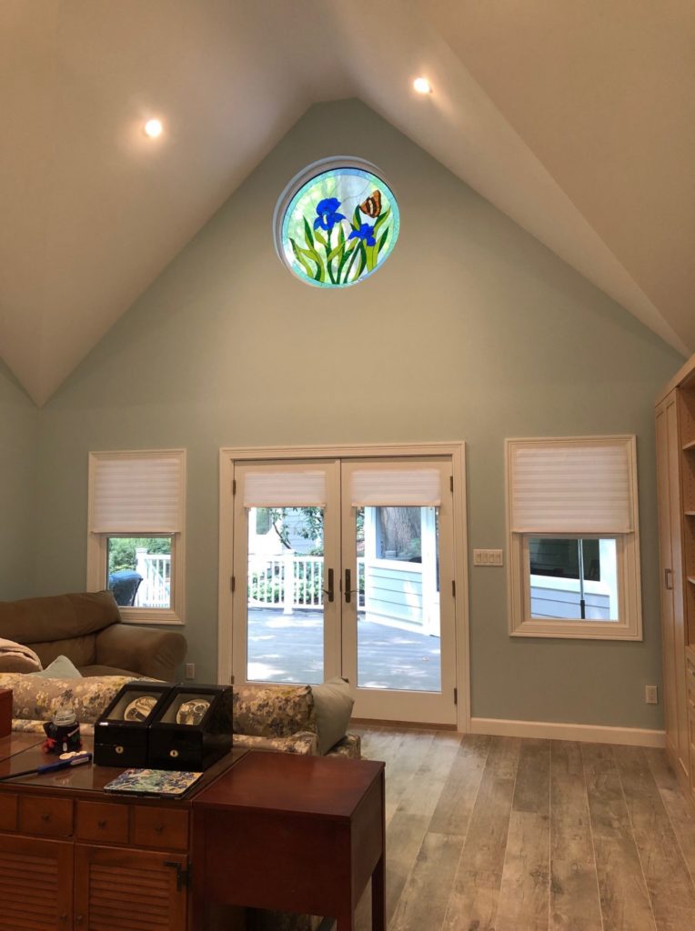 Round Iris & Butterfly Window Installed In A Living Room