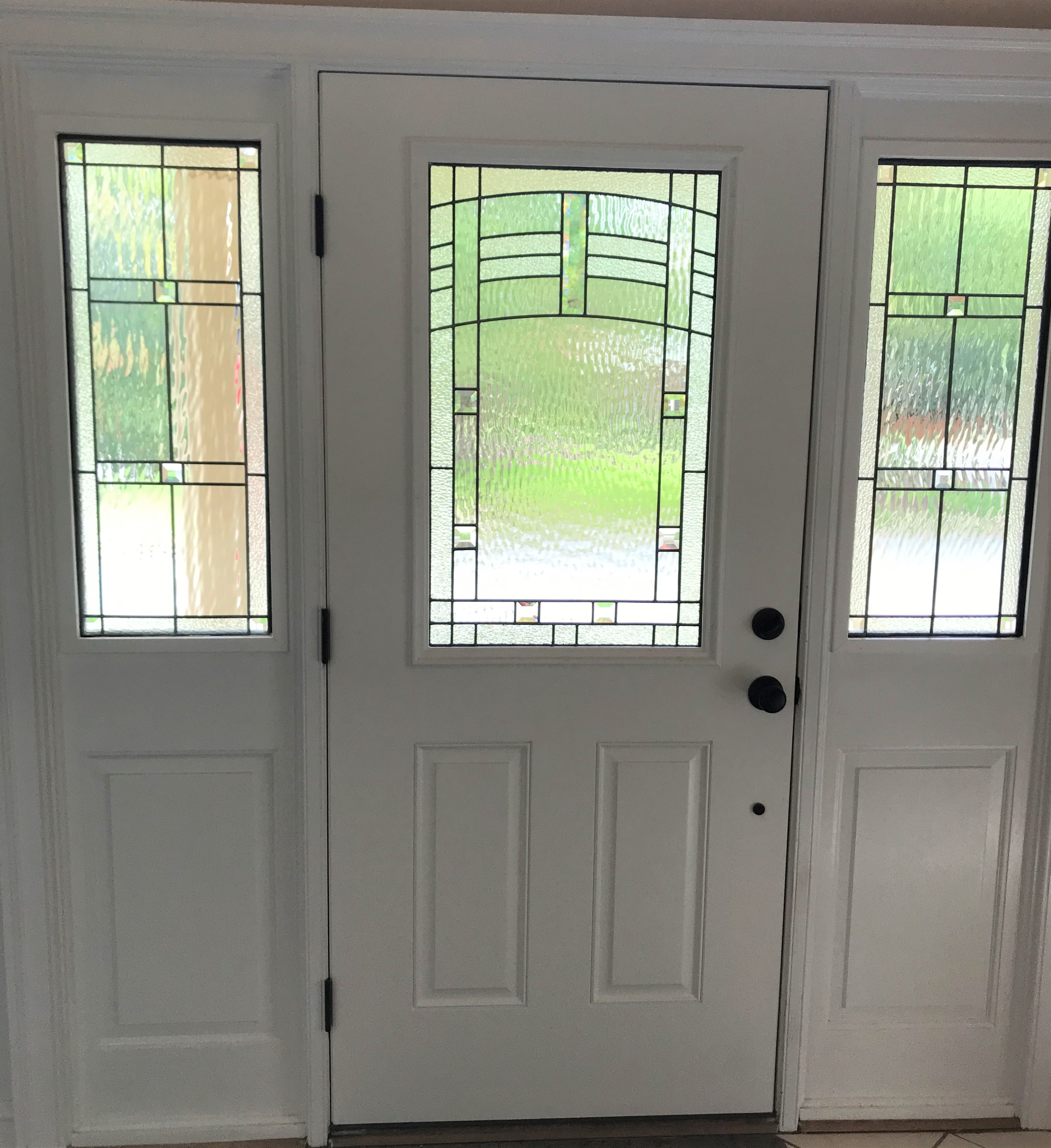 Client had existing door and clear glass in sidelights. We created