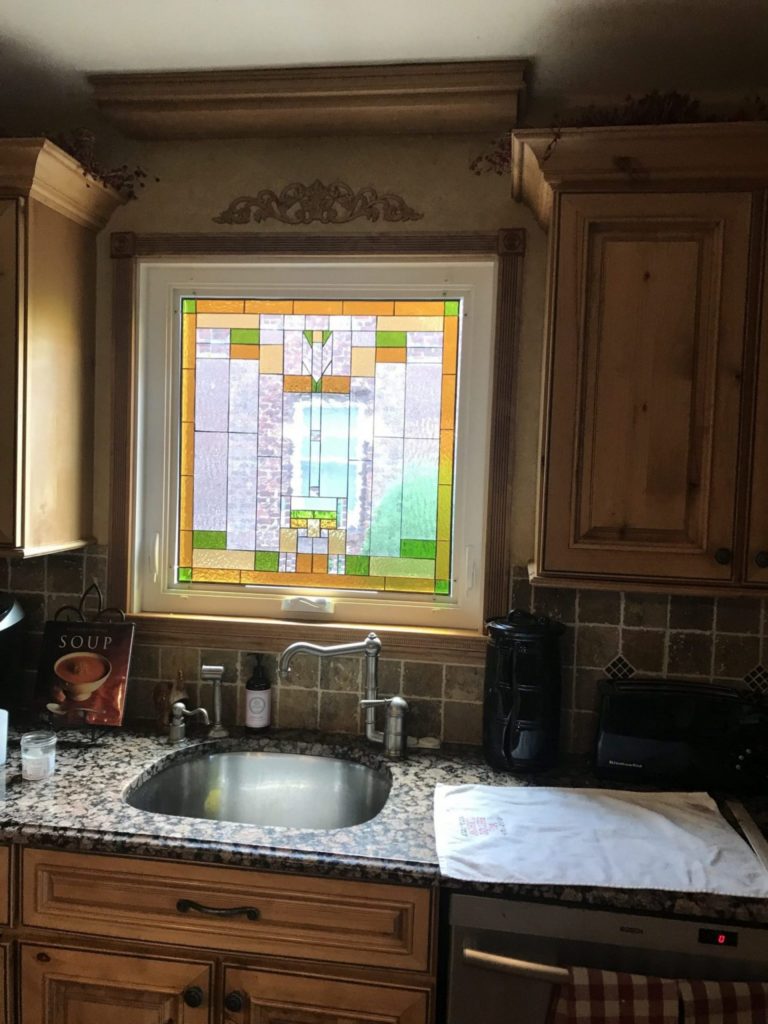 Single pane stained glass mounted onto clients awning vinyl frame