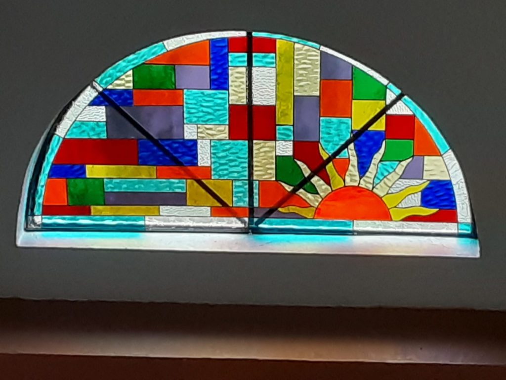 Arched colorful sun setting Stained Glass Insert Installed