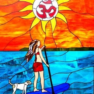 A vibrant leaded stained glass panel depicting a woman paddleboarding with a white dog on blue water, under a bright orange and yellow sun featuring a red Om symbol.