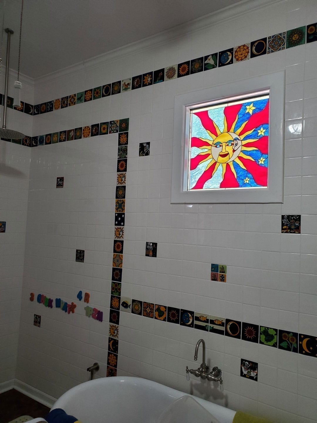 Sun & Moon Stained Glass installed in a bathroom window