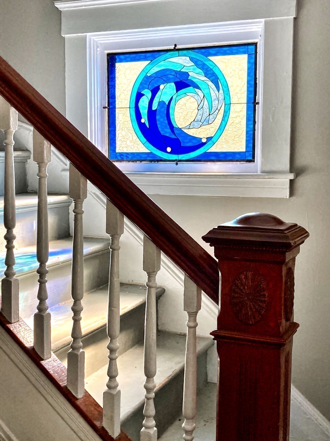 Deep Blue Cresting wave design installed in a Stairway Window