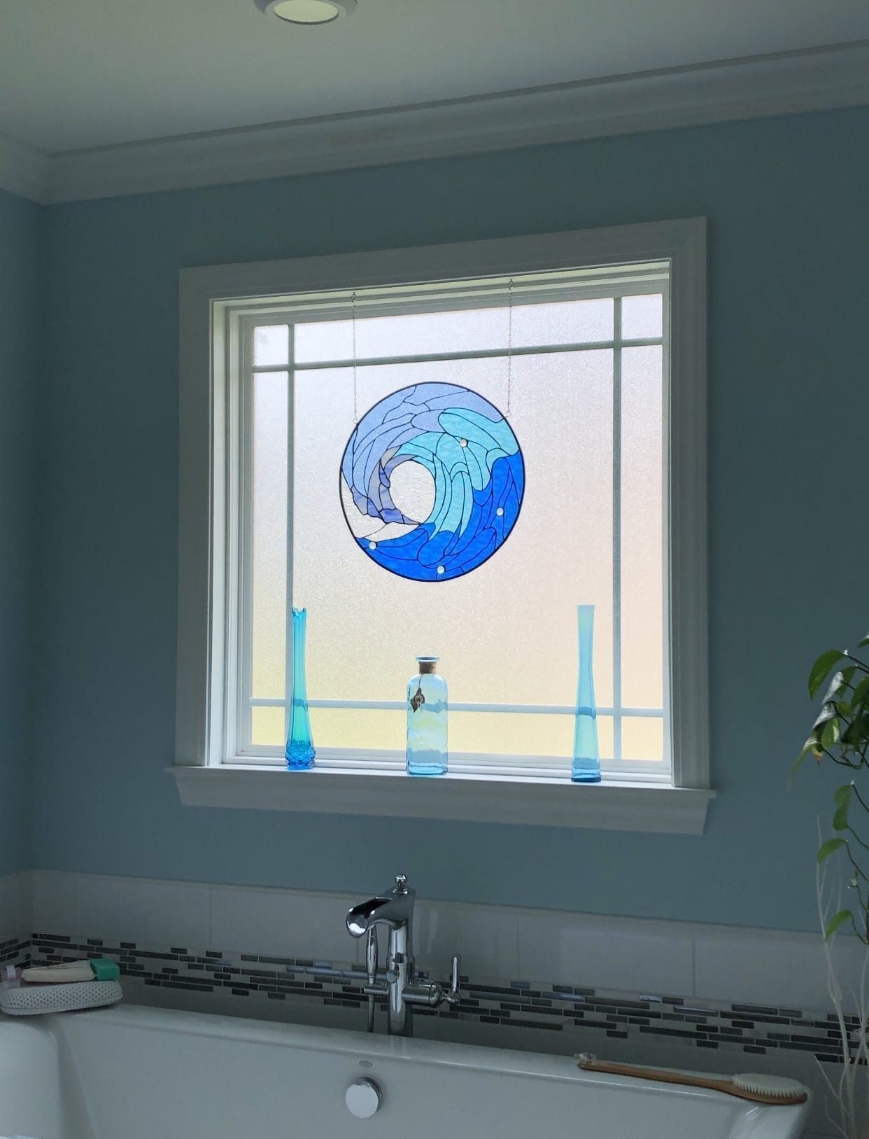 Blue Cresting Wave Design Stained Glass Installed over a bathtub