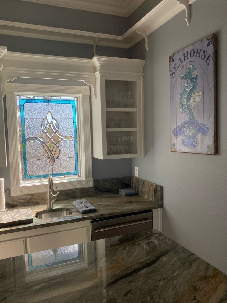 Clear Stained Glass Window with a touch of color installed over a Kitchen Sink