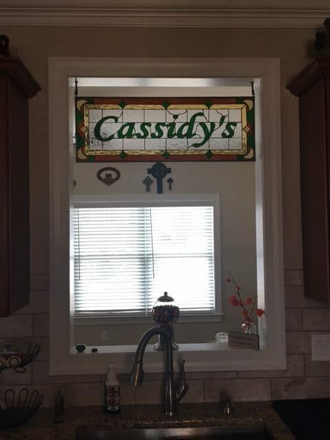 Family name with a Celtic theme hung as a transom window