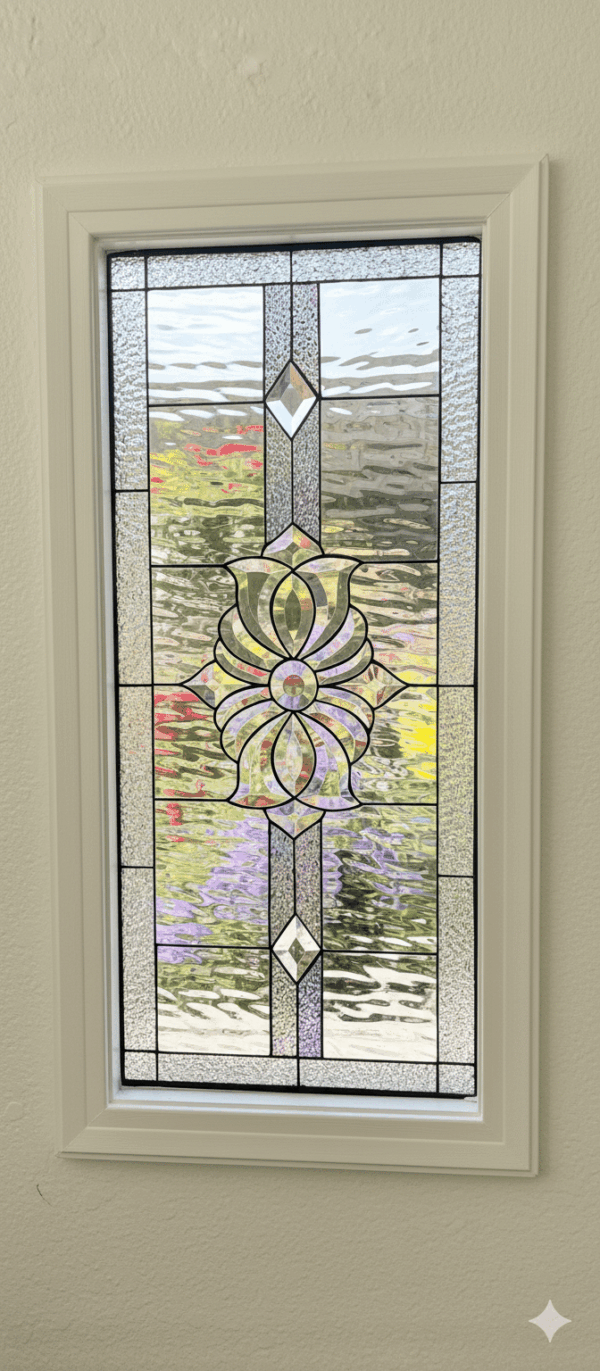 A rectangular stained glass panel with a symmetrical design. The centerpiece is a large, ornate beveled glass cluster, accented by a beveled diamond above and below. The panel is made entirely from clear, textured privacy glass.