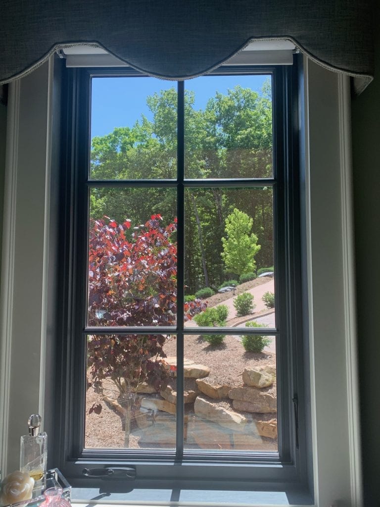 An elegant clear beveled and textured leaded stained glass panel designed to fit a six-pane casement window, allowing diffused light and privacy while hinting at the vibrant outdoor landscape visible through it.