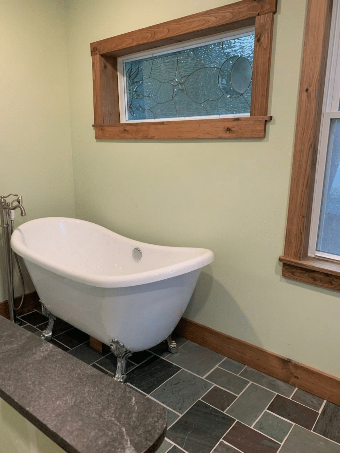 A rectangular, leaded stained glass window featuring a central star and a crescent moon, crafted from clear textured and subtly tinted blue-green glass.